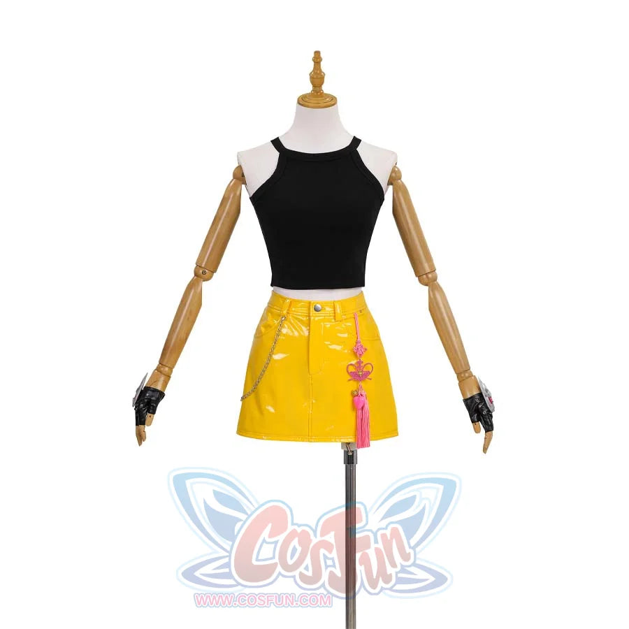 howcases Mira’s outfit-black halter crop top paired with a yellow patent - leather skirt, accessorized with pink tassels and chains, plus matching gloves.