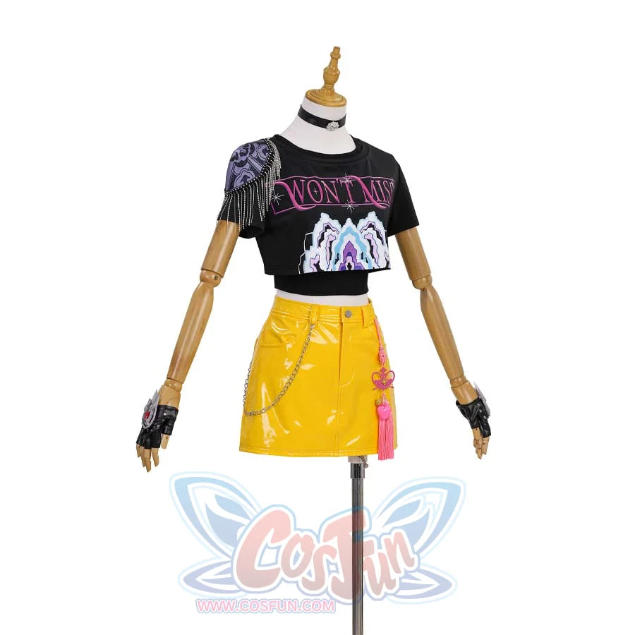 Displays a variation of Mira’s look-black graphic tee, yellow patent skirt with chain, pink tassels, and newly styled gloves for an edgier vibe.