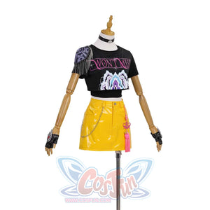 Displays a variation of Mira’s look-black graphic tee, yellow patent skirt with chain, pink tassels, and newly styled gloves for an edgier vibe.