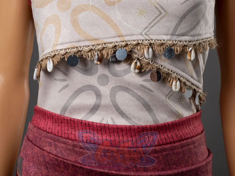 Moana cosplay costume waist close-up showing decorative shell and coin fringe trim at the hem of the patterned top