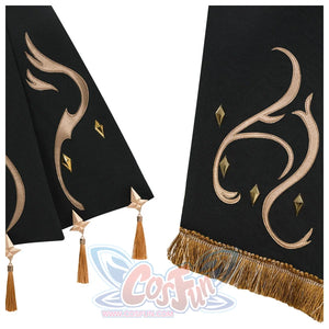 Close - up of black fabric sections with gold embroidered patterns and tassels. The gold detailing and fringe add a touch of elegance to the costume
