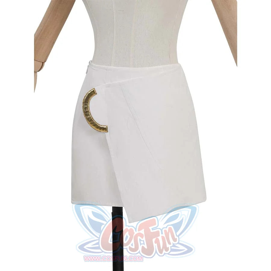 Close - up of a white asymmetrical skirt with a gold decorative piece. It’s a separate part, likely an accessory to the full costume.