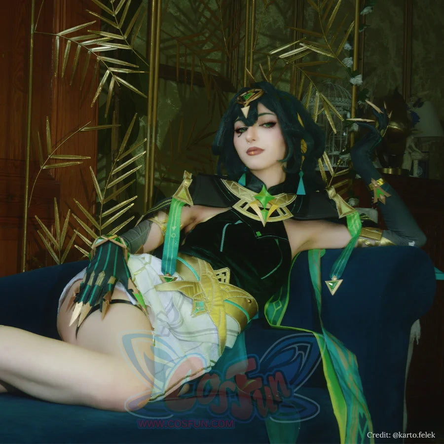 Genshin Impact Nefer cosplay costume modeled in sitting pose, showcasing dark green outfit with golden accents