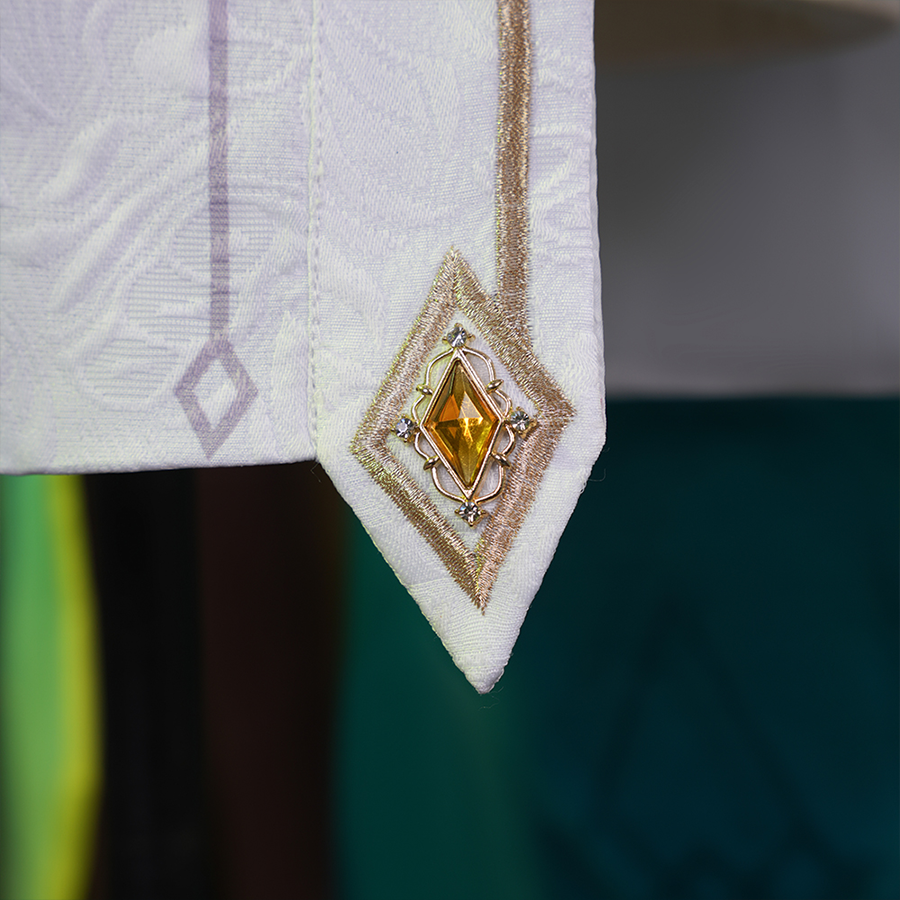 Genshin Impact Nefer Cosplay Costume close-up of white skirt, showing golden embroidery design.