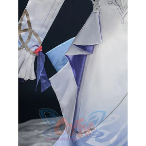 Nicole cosplay costume waist close-up showing layered blue and white fabric panels with a decorative red element and silver chain.