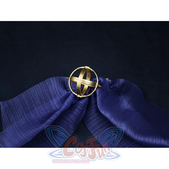 Nicole cosplay gold circular brooch with cross design, displayed on blue satin fabric, an included accessory for the costume.