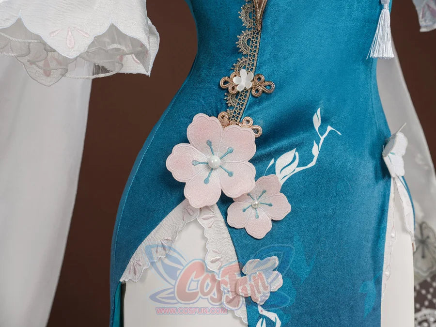Ruan Mei cosplay costume skirt close-up with pink plum blossom appliques, Chinese knot clasp, white tassel, and lace trim.