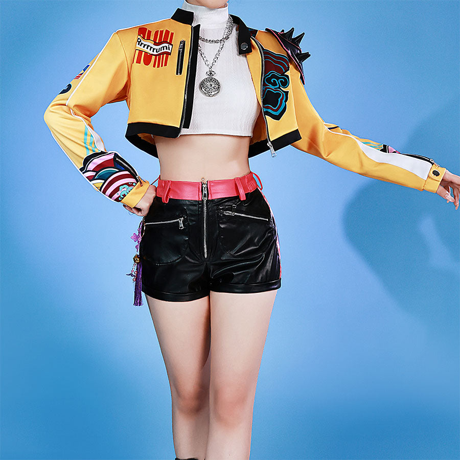 Idol Rumi cosplayer wearing a colorful jacket and black shorts on a blue background