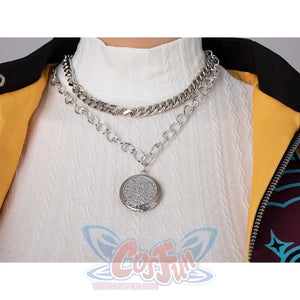 Close - up of layered silver chains with an ornate pendant, part of Rumi’s cosplay costume, worn over a white top.