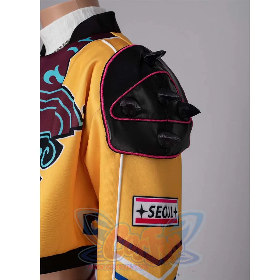 Close - up of the black spiked shoulder pad with pink trim on Rumi’s yellow cosplay jacket, along with the “SEOUL” patch.