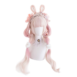 Model wearing long pink ombre curly cosplay wig with white J-Fashion Lolita outfit