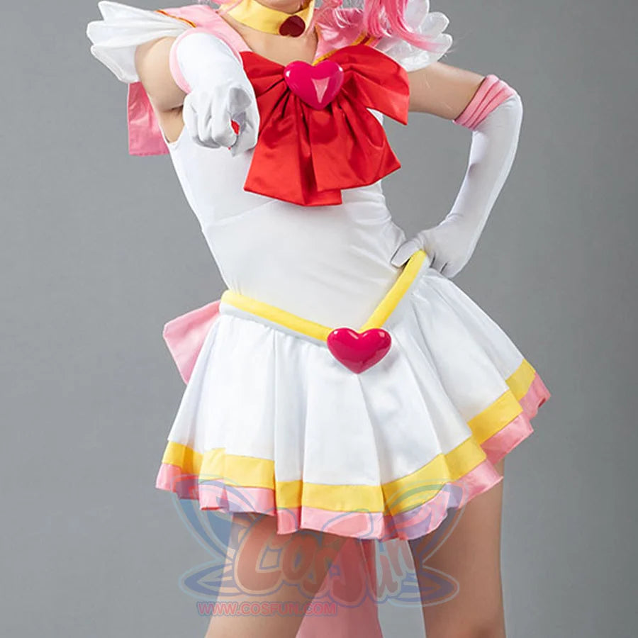 Sailor Chibiusa Rini cosplay dress layers pink and yellow trim around a red heart-emblem bow and gold choker.