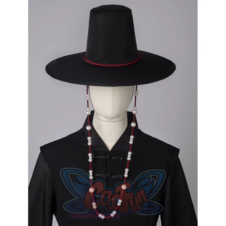 A black high-topped wide-brimmed hat with red strings on both sides, adorned with white round beads.