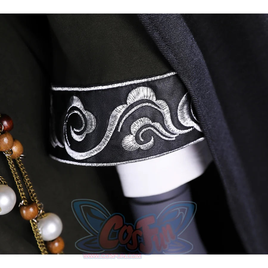 A close-up of the sleeve detail on the Sister Friede cosplay costume, showing the intricate silver embroidery on the dark green fabric.