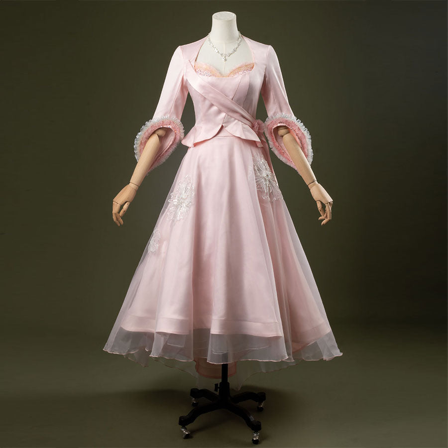 Glinda cosplay costume set featuring pastel pink vintage-inspired gown, ruffled lace cuffs, lace-trimmed sweetheart top, tulle overlay skirt, and necklace.
