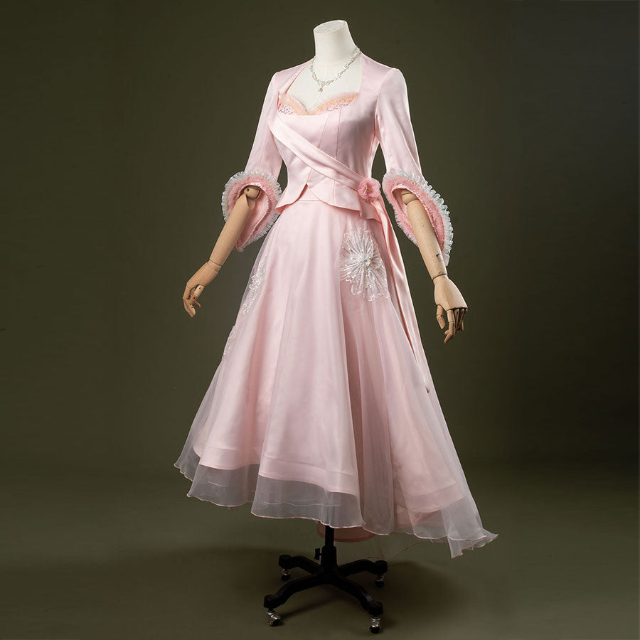 Glinda cosplay costume set featuring pastel pink vintage-inspired gown, ruffled lace cuffs, lace-trimmed sweetheart top, tulle overlay skirt, and necklace.