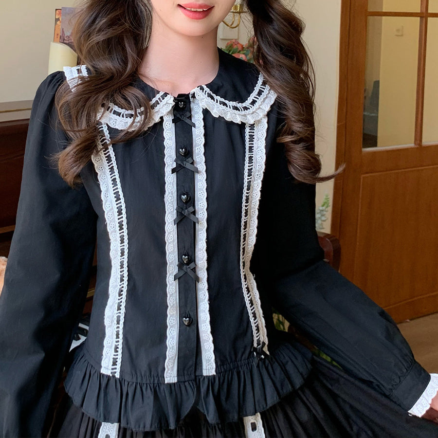 Black Lolita long sleeve blouse with white lace Peter Pan collar, heart buttons, and black bows, front view.