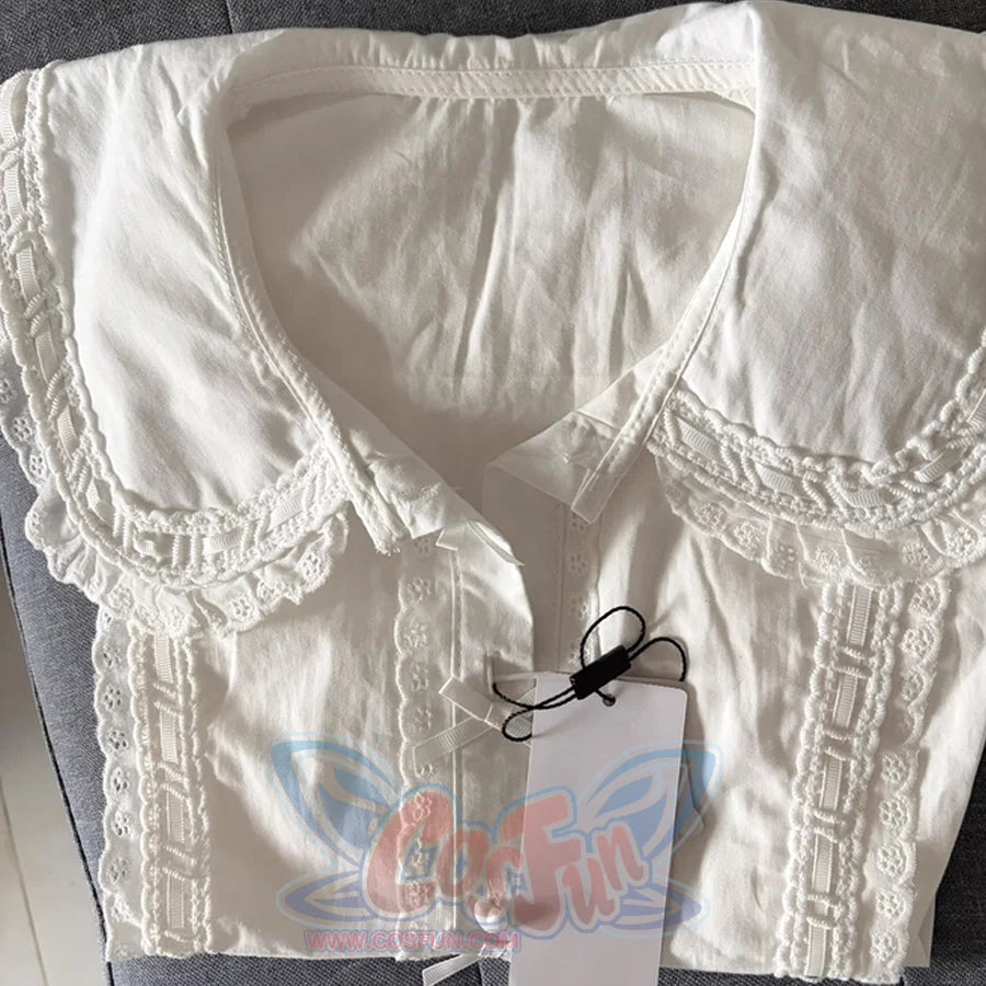 Flat lay of white Lolita blouse highlighting the wide lace-edged Peter Pan collar and eyelet lace front placket.