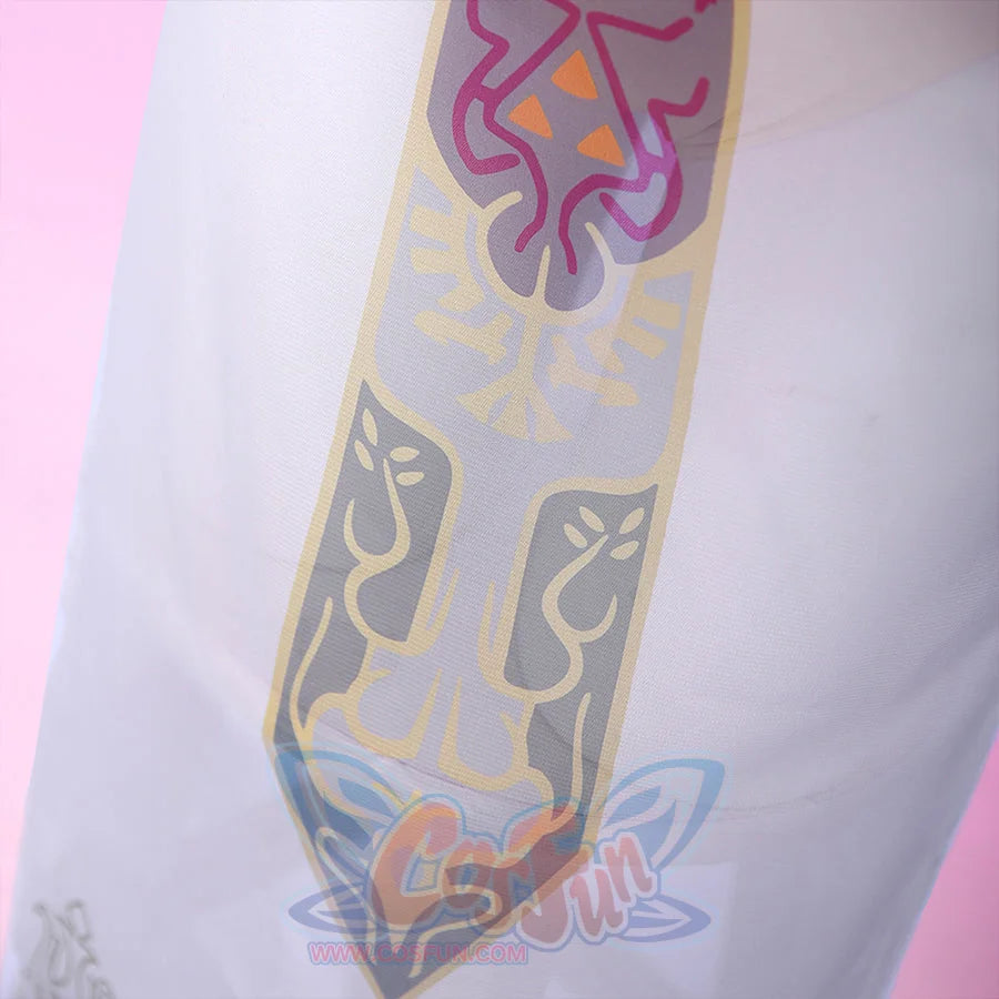 Detailed close-up of the Princess Zelda crest emblem on the cosplay sheer skirt, with multicolor print in pink, gold, and gray on white.