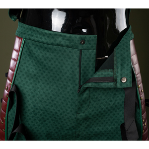 The pants are form-fitting with intricate textured patterns, accentuating the body shape.