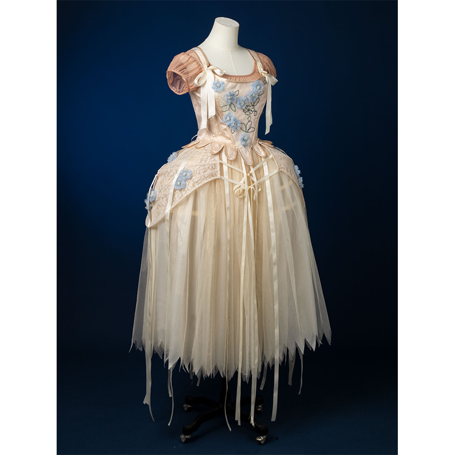 Enid Sinclair Gala dress right side view with blue floral embroidery, puff sleeves, ribbon bow, cream tulle ball gown