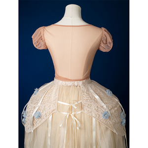 Enid Sinclair Gala dress top back view with peach puff sleeves, open back design, cream tulle skirt, blue floral appliques