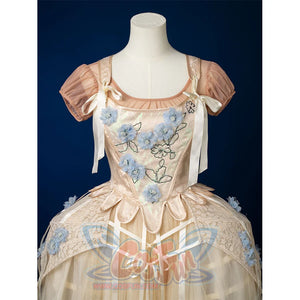 Enid Sinclair Gala dress upper body detail showing blue floral embroidery on bodice, off-shoulder puff sleeves, ribbon ties