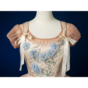 Enid Sinclair Gala dress vest bodice close-up with blue floral embroidery, satin fabric, pearl accents, puff sleeves