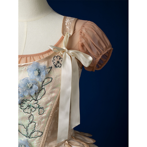 Enid Sinclair Gala dress vest strap detail with embroidered ribbon, puff sleeve, cream tie, floral embroidery pattern