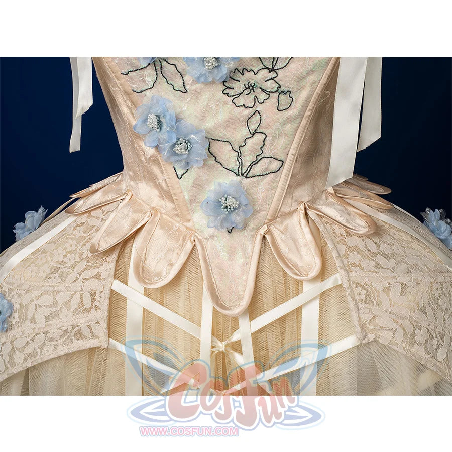 Enid Sinclair Gala dress waist detail with ribbon bow, lace-up corset back, blue floral embroidery, cream layered skirt