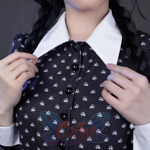 Wednesday cosplay dress close-up showing white collar, black buttons, and floral pattern fabric detail