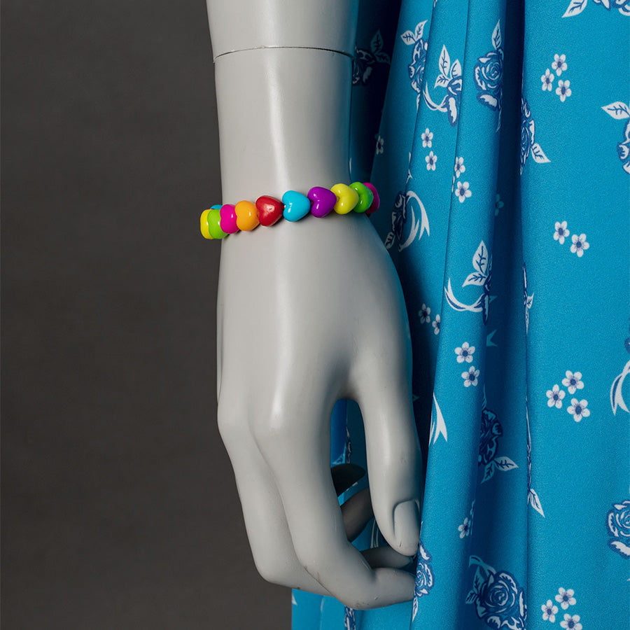 Wheeler cosplay costume accessory detail with colorful beaded bracelet and blue floral dress