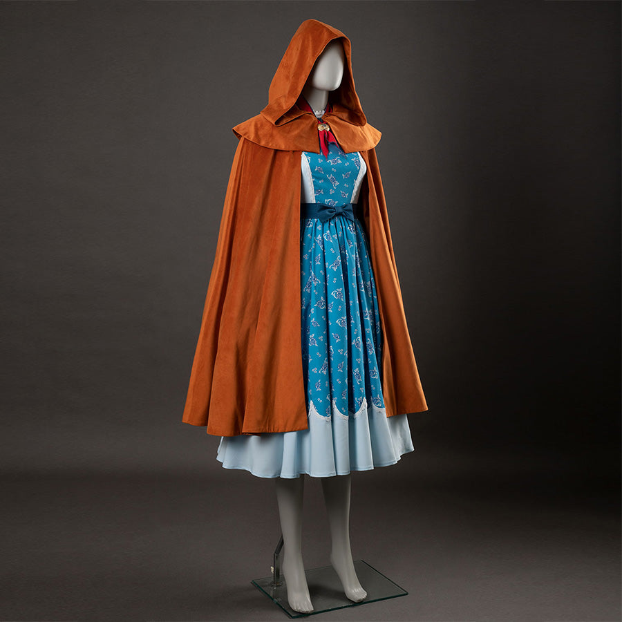 Holly cosplay back view showing yellow-brown hooded cloak, blue floral dress with white bodice and hem