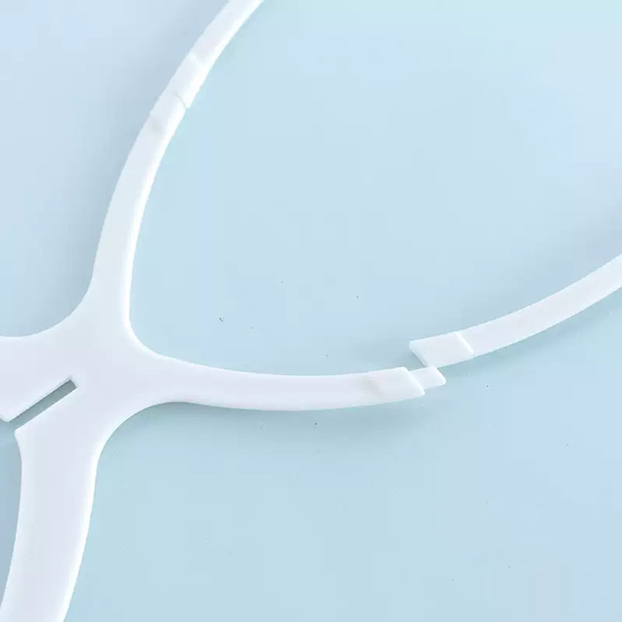 Close-up of white wig rack head connector joint detail