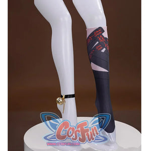 On the left side there is a black belt with a golden bell hanging from it and on the right side are black and pink socks with red charms on the design of the socks.