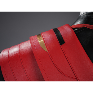 Cristoforo cosplay costume cloak decoration detail with red layered leather panels, gold accent strip, black trim borders