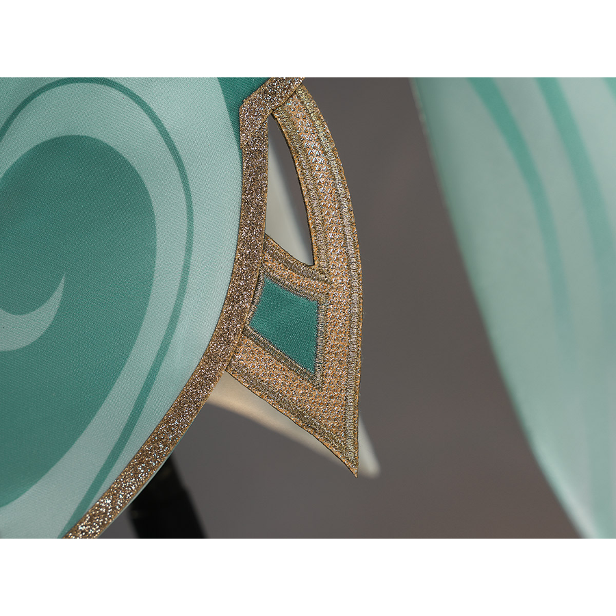 Zibai cosplay costume hem trim close-up with intricate gold embroidered pattern on teal