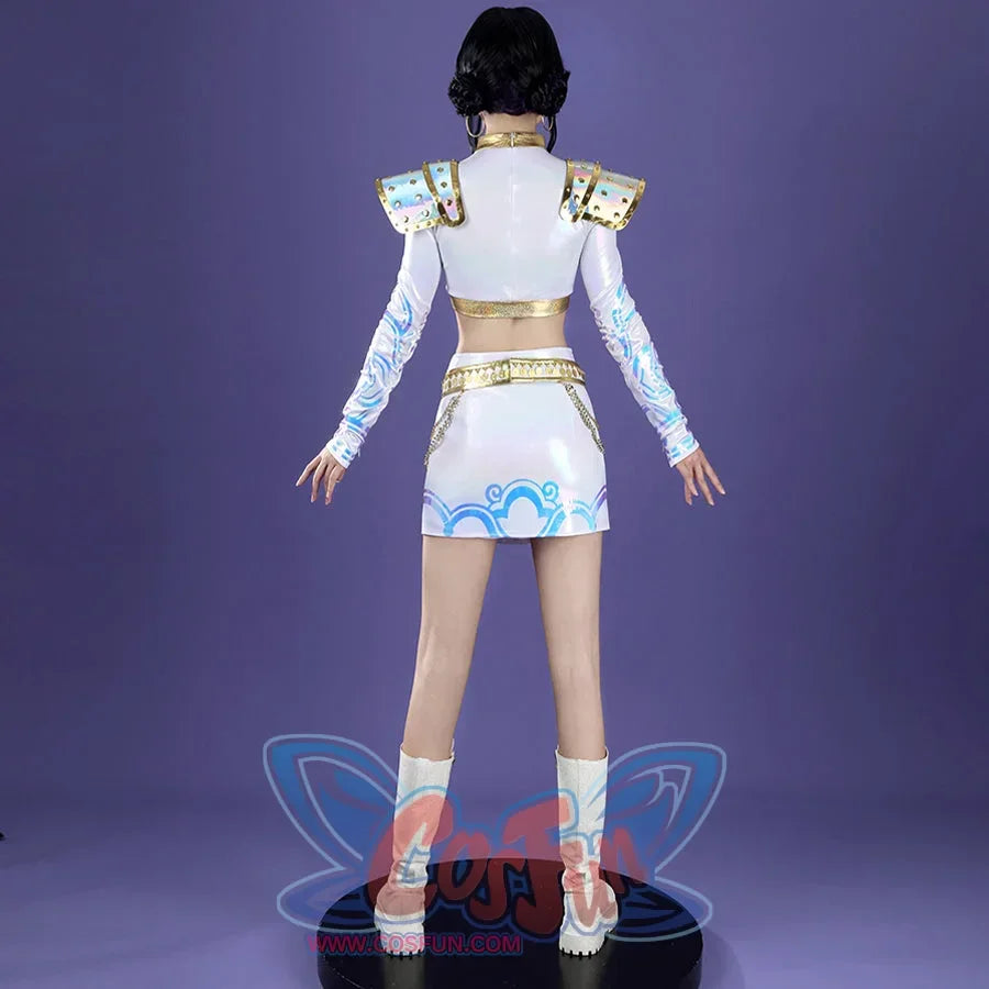 From the back, Zoey’s cosplay reveals iridescent shoulder armor, gold - lined crop top and skirt waist, patterned sleeves, and blue skirt designs, paired with white boots on a purple backdrop.