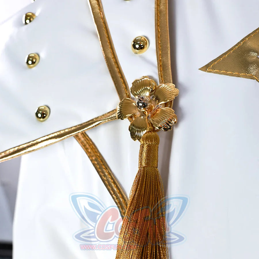 Shows the gold flower - shaped ornament with a tassel on Zoey’s top, highlighting the delicate and decorative front design.