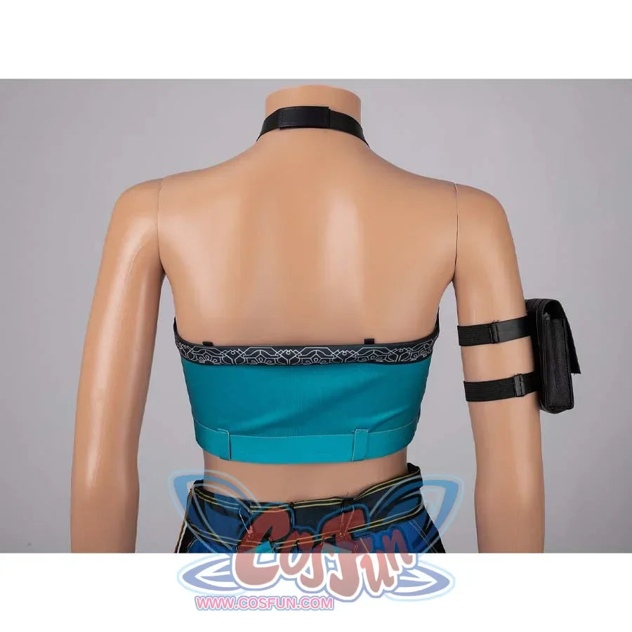 Rear view of Zoey’s turquoise crop top with patterned trim, paired with a black arm pouch.
