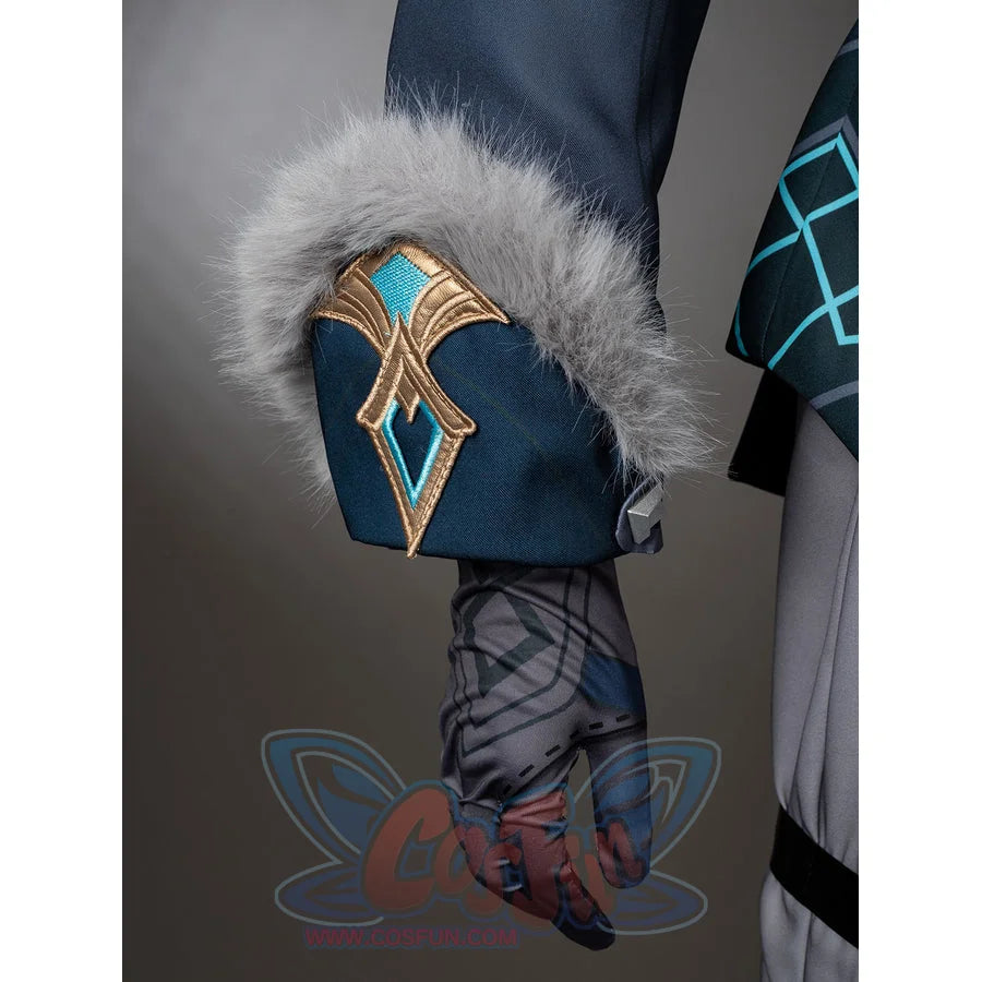 Aether cosplay cuff detail with gray fluffy trim and a gold-tone ornament over a dark teal sleeve.