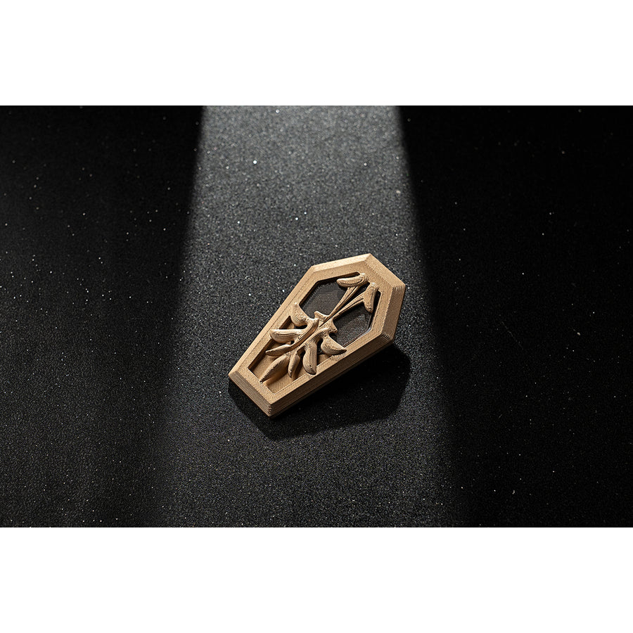 Genshin Impact Amber cosplay armband emblem accessory appears as a carved gold-tone piece.