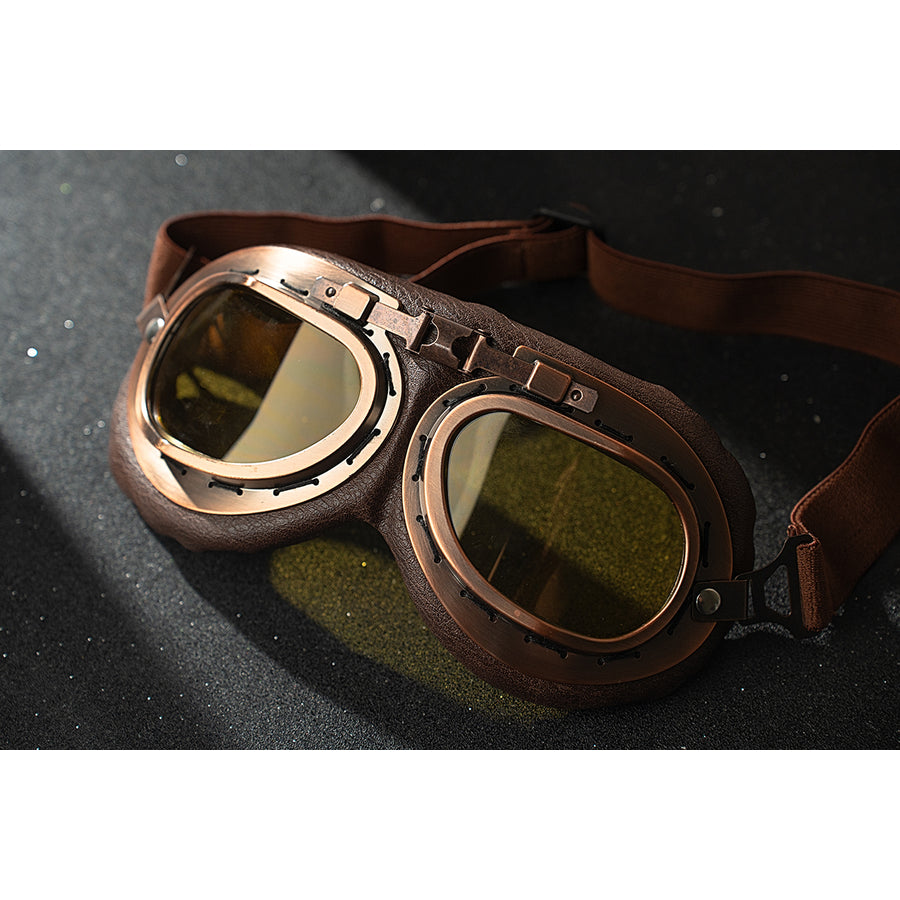 Genshin Impact Amber cosplay goggles close-up shows brown straps and translucent yellow lenses.