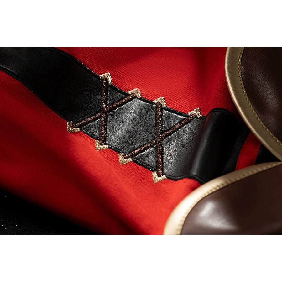 Genshin Impact Amber cosplay sleeve lacing detail shows black crisscross straps bordered by gold trim.