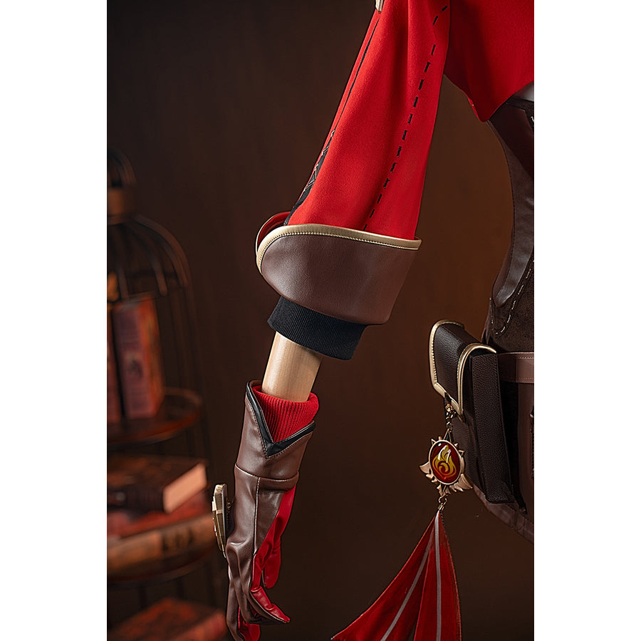 Genshin Impact Amber cosplay vision side accessory hangs from the red coat beside the brown cuff.