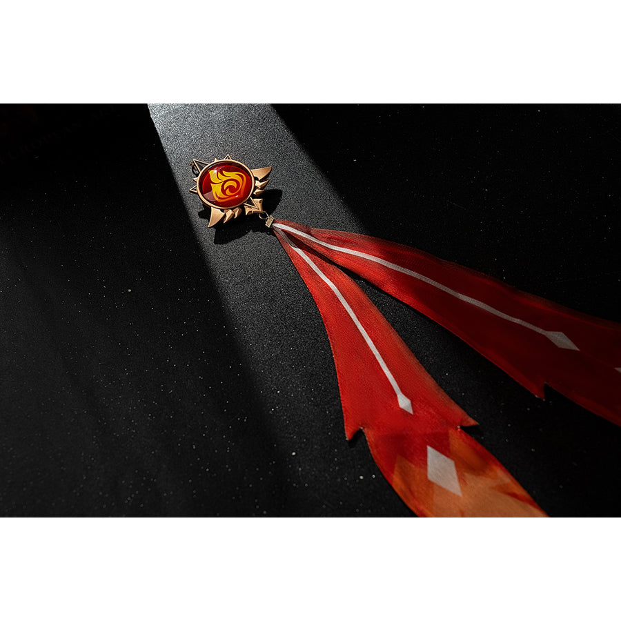 Genshin Impact Amber cosplay vision tassel detail shows red ribbons fading into an orange flame shape.