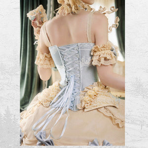 Back view showing pale blue lacing, fitted waist, and ruffled shoulder details
