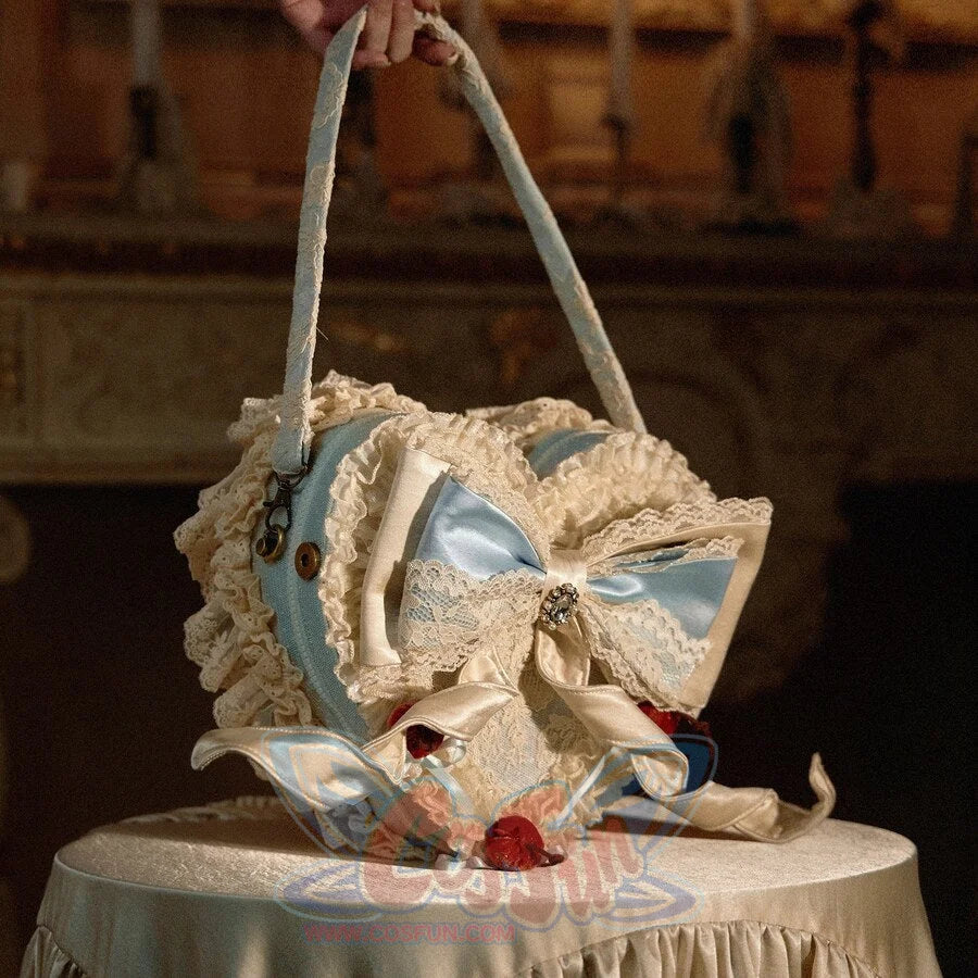 Blue heart cake handbag angled view showing lace trim, side depth, and shoulder handle