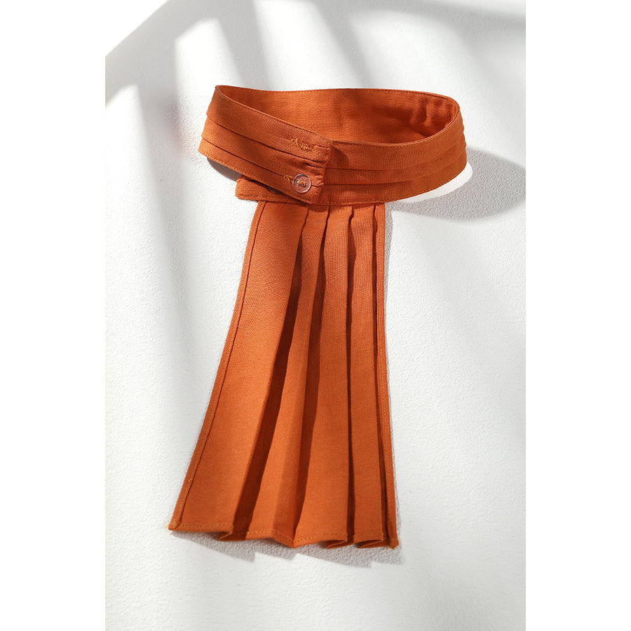 Buggy the Star Clown cosplay orange scarf detail shows the folded neck wrap and long pleated tail