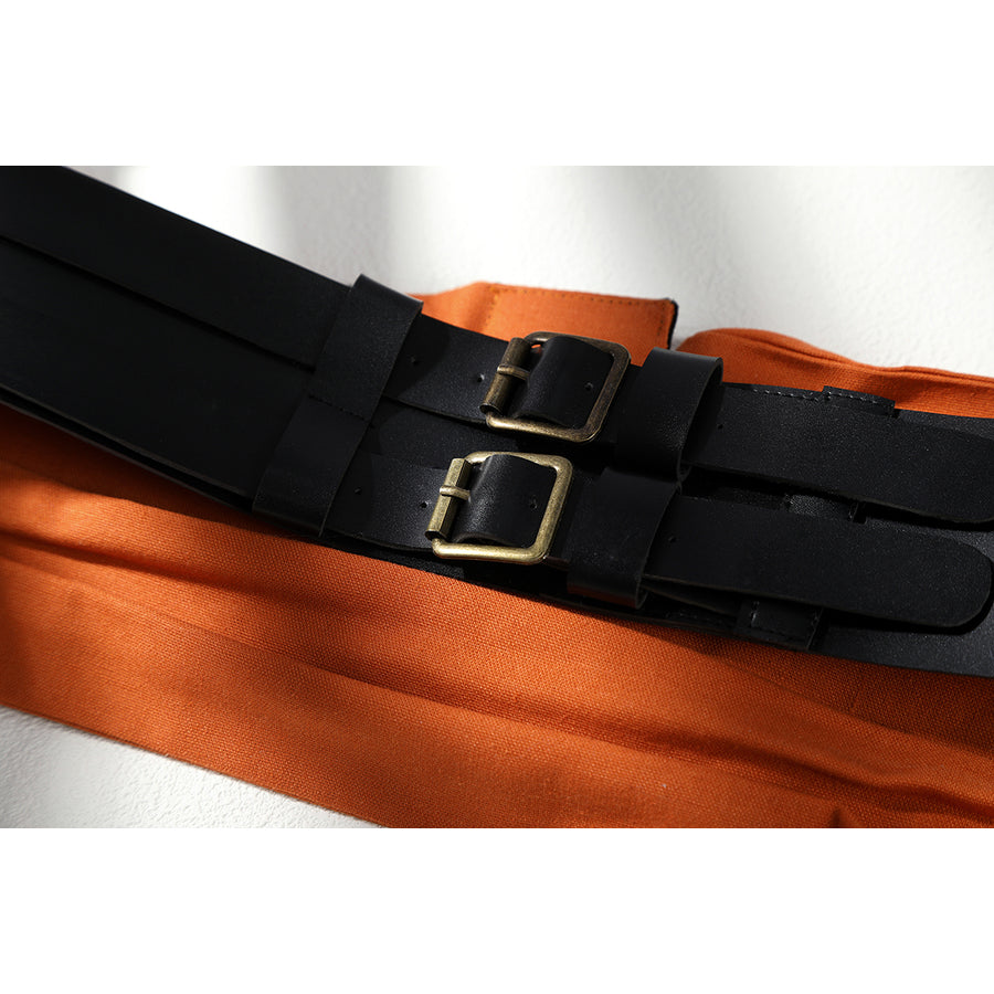 Buggy the Star Clown cosplay waist seal close-up focuses on black straps and brass-tone buckles